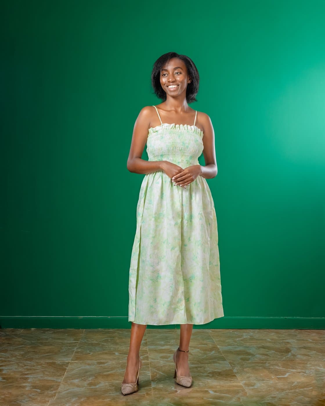 Nyawira Vivian Gichuhi smiling in a green midi dress